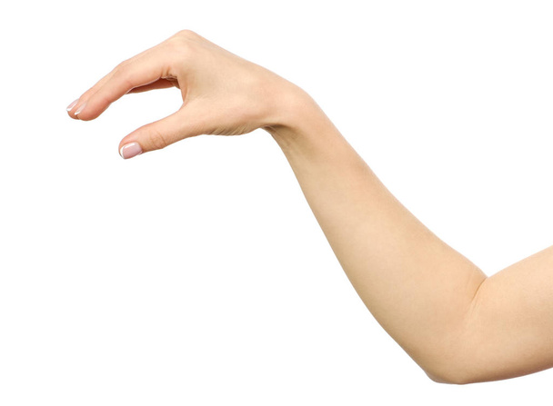 Woman's hand grabbing or measuring something - Фото, изображение