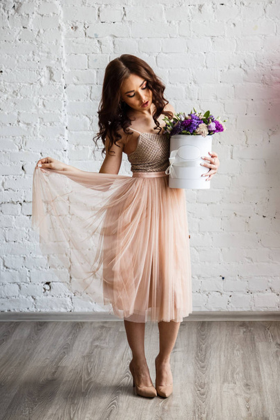 Young brunette in beautiful dress with flowers - Foto, Imagem