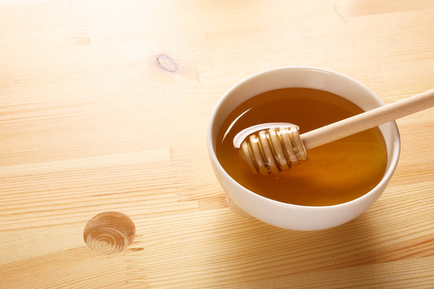 Honey on a wooden background - Photo, image