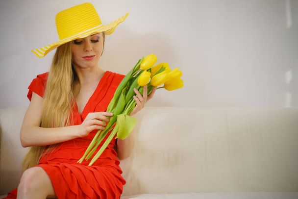 Lovely woman with yellow tulips bunch - Zdjęcie, obraz