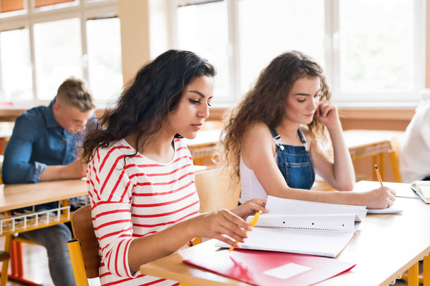 Three high school students at school learning. - Photo, image