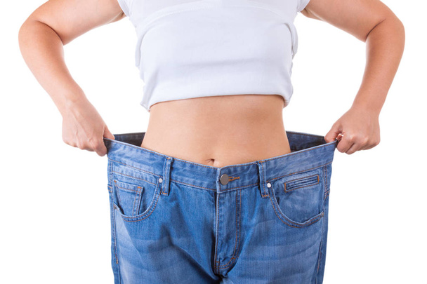 Diet Concept. Slim Women in Big Jeans Showing Successful Weight  - Fotó, kép