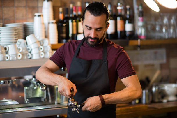 barista man making espresso at bar or coffee shop - Fotó, kép