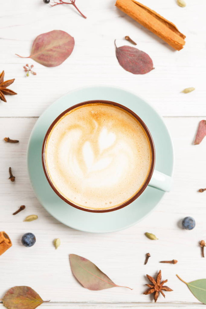 Autumn cappuccino coffee cup on white wood background - Photo, Image