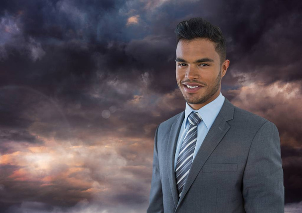 Businessman under dark sky clouds - Foto, Bild