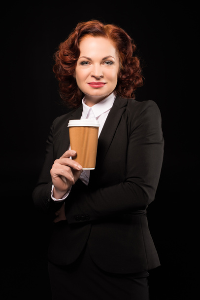 Businesswoman with disposable coffee cup - 写真・画像