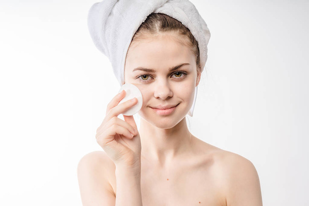 Beautiful woman cleaning her face - 写真・画像