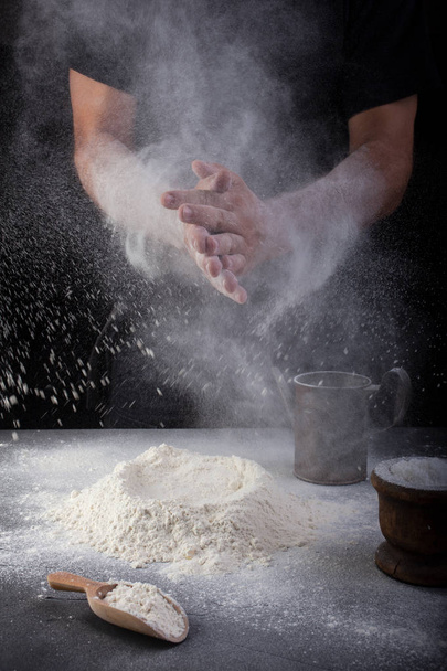Baker clapping hands of flour  - 写真・画像