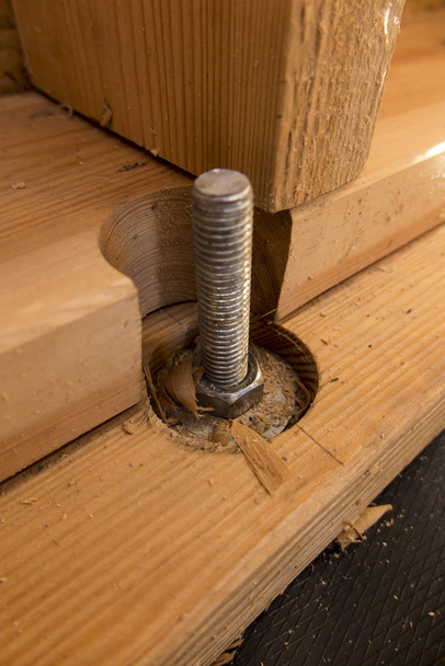 screw fixing wooden slats to concrete - Photo, Image