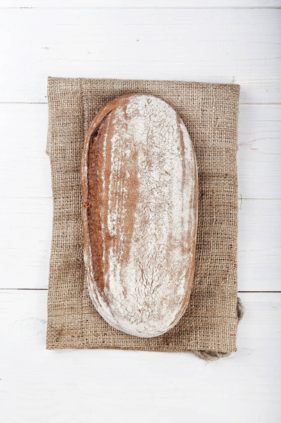 rye bread on a wooden background - 写真・画像
