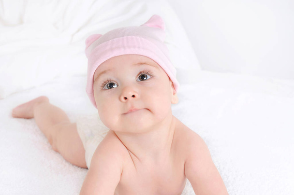 Close up picture of a cute little baby girl wearing at pink hat - Фото, зображення