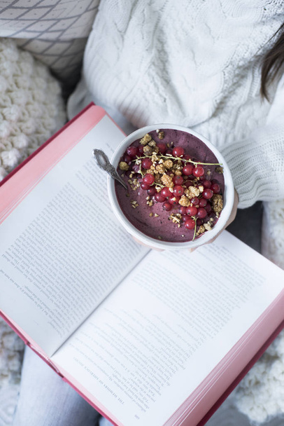 woman holding book and Acai Bowl  - 写真・画像
