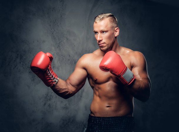 Boxeador de patadas sin camisa mostrando sus golpes
 - Foto, imagen