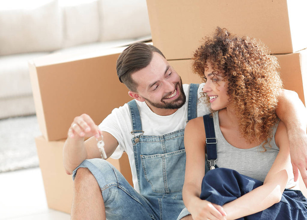 smiling couple on the background of large cardboard boxes. - Photo, Image