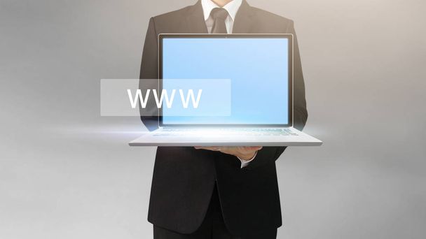 Handsome business man and suit holding laptop in hands  - Photo, Image