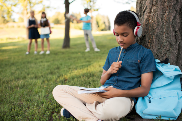 african american boy studying in park - Photo, Image