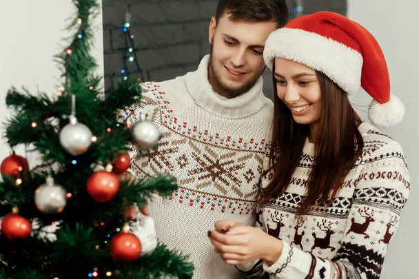 woman and man decorating Christmas tree - Photo, Image