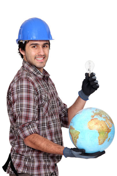 Electrician holding globe and light bulb - Foto, imagen