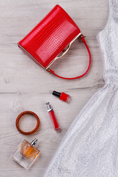 Red handbag, fashion cosmetics, evening dress. - Photo, Image