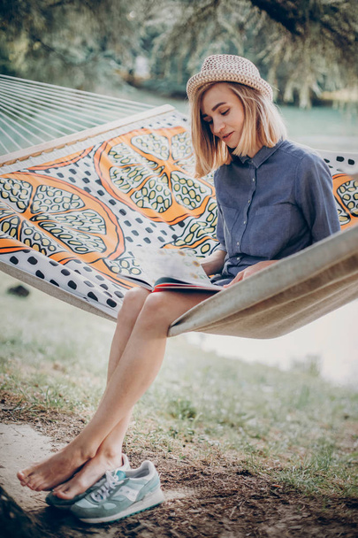 girl reading book on hammock - Photo, Image