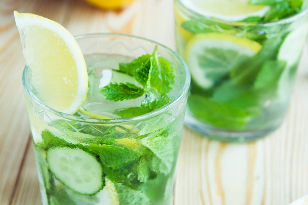 Detox water, fresh organic lemonade with ice, cucumber, lemon an - Foto, Bild