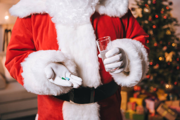 santa claus with glass of water and pills - Photo, Image