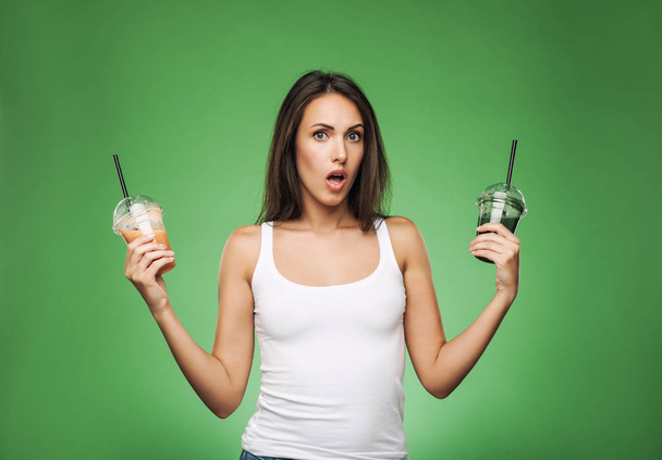Young surprised woman holding smoothie - Foto, Bild