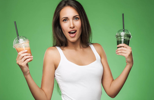 Young surprised woman holding smoothie - Φωτογραφία, εικόνα