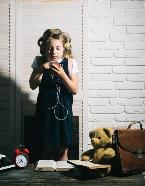 Child with briefcase and alarm clock. - 写真・画像