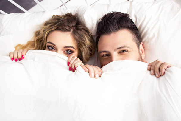 Couple lying in bed - Фото, изображение
