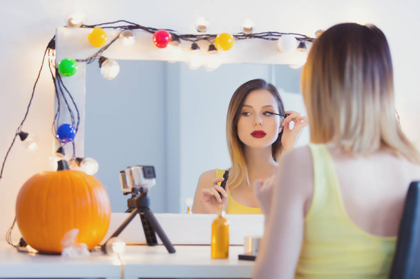 Woman applying cosmetics at camera  - Photo, Image
