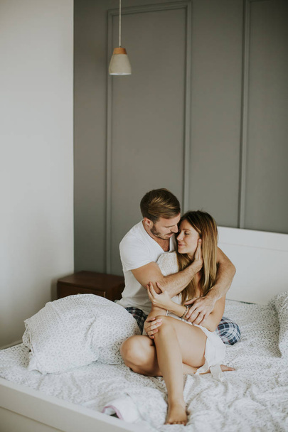 Loving couple on bed in the room - Foto, Imagen