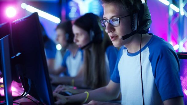 Team of Teenage Gamers Play in Multiplayer PC Video Game on a eSport Tournament. Captain Gives Commands into Microphone, Trying Strategically Win the Game. - Fotó, kép