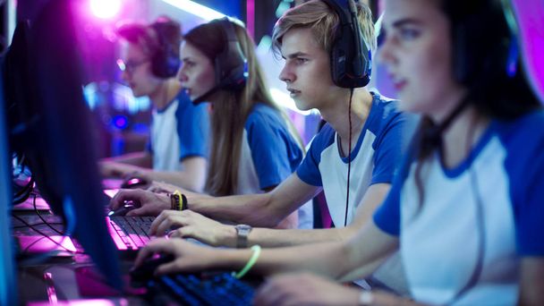 Team of Professional eSport Gamers Playing in Competitive Video Games on a Cyber Games Tournament. They using Microphones. - Photo, image