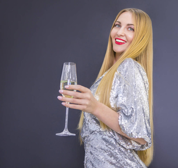 Young pretty smilling woman with glass of champagne - Zdjęcie, obraz