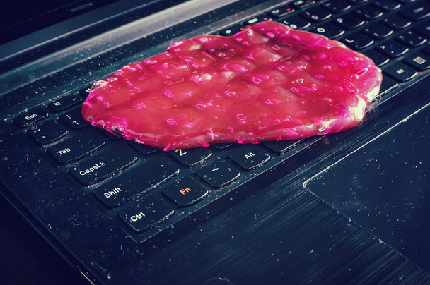 Keyboard cleaning gel is laying on the notebook. - Photo, Image