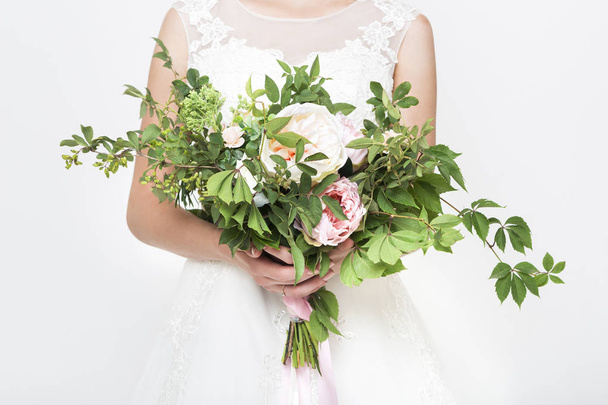 Young pretty bride with wedding bouquet - Fotó, kép