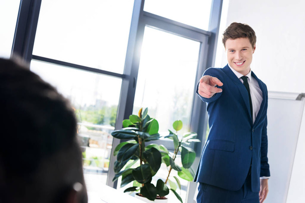 businessman pointing at colleague - 写真・画像
