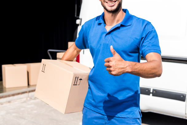 delivery man showing thumb up - Fotó, kép