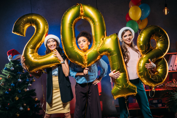 young friends with golden balloons - 写真・画像