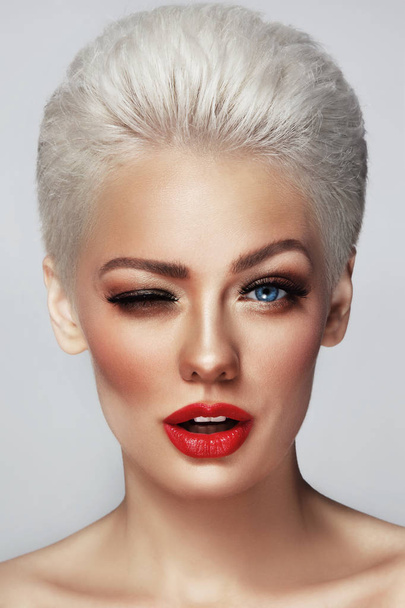 blonde winking woman with red lipstick - Zdjęcie, obraz