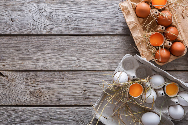 Fresh brown eggs in carton on rustic wood background - Photo, Image
