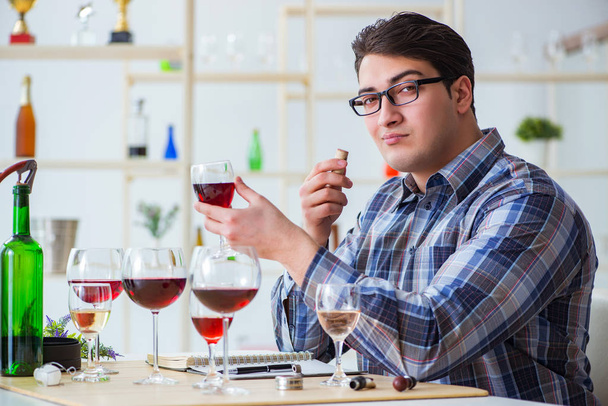 Professional sommelier tasting red wine - Photo, Image