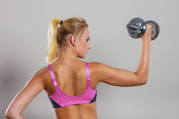 Fit woman lifting dumbbells weights - Photo, image