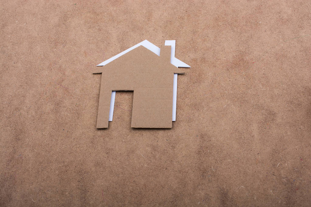 Little paper houses on a brown background - Photo, Image