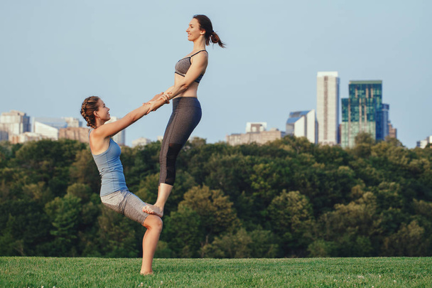 duas mulheres fazendo acro ioga
  - Foto, Imagem