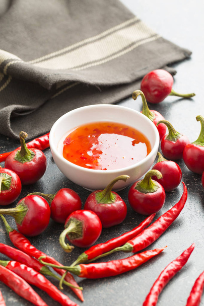 Red chili peppers and chili sauce. - Valokuva, kuva