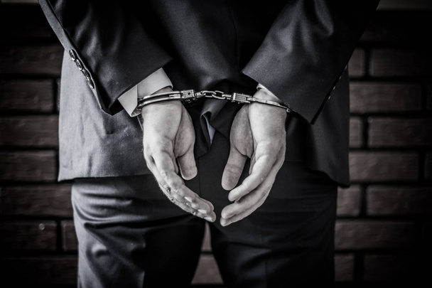 Businessman and his hands on the back handcuffed because of crim - Φωτογραφία, εικόνα