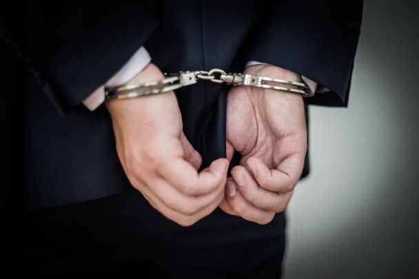 Businessman handcuffed for corruption, money laundering, tax eva - Photo, Image