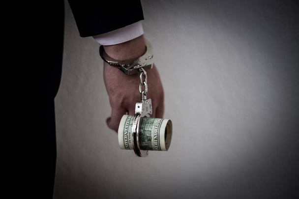 A businessman caught with handcuffs on his stomach for corruptio - Fotoğraf, Görsel
